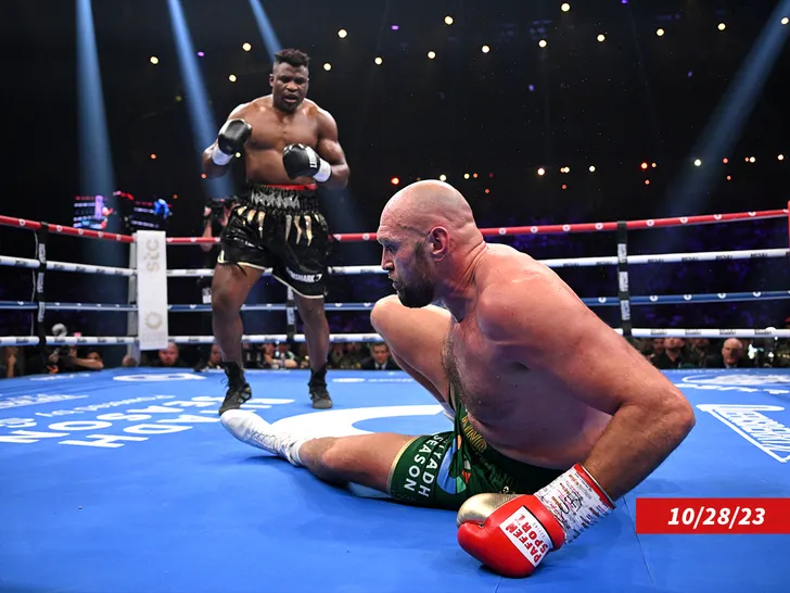 Deontay Wilder standing confidently with boxing gloves, ready for a potential fight with Francis Ngannou.