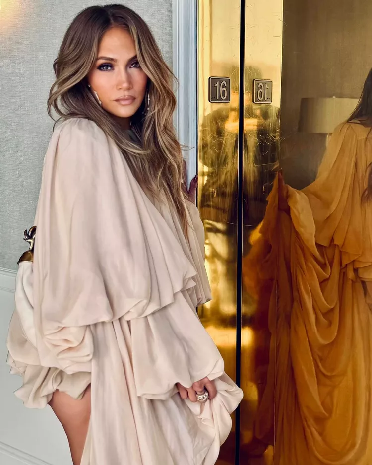 Jennifer Lopez wearing a beige boho romper with flowing sleeves during the promotional tour for Unstoppable.